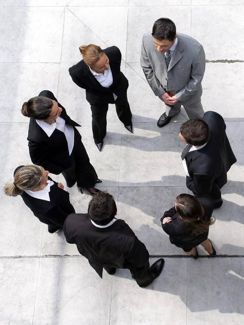 Aerial view of seven business people standing in a circle