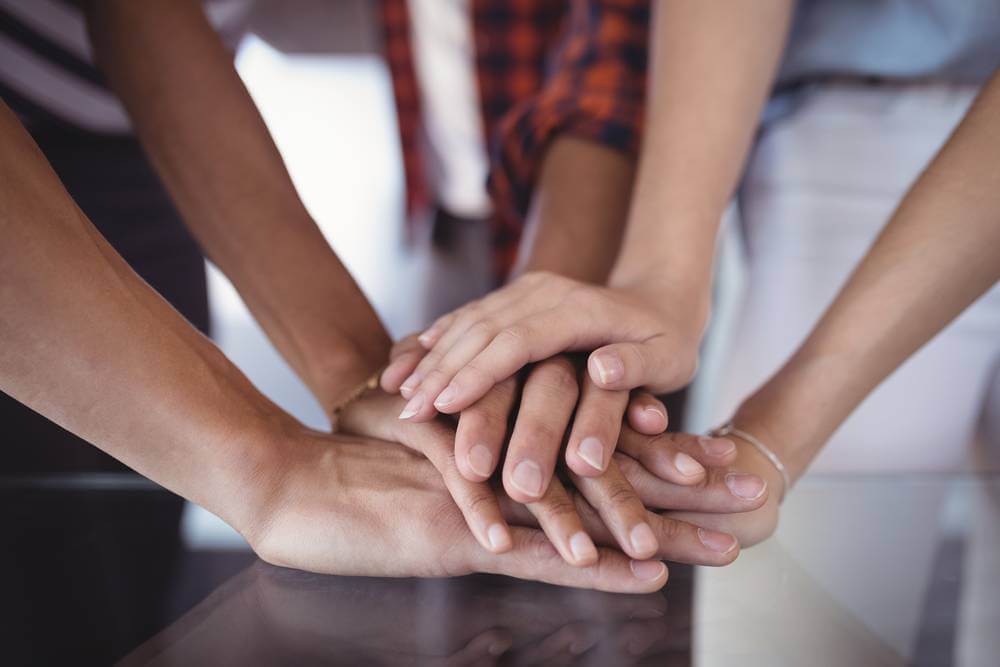 Close up of hands stacked on top of each other